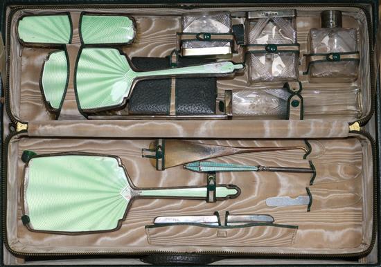 A 1930s Art Deco travelling toilet case containing eight silver mounted items by Walker & Hall,